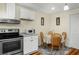 Cozy eat-in kitchen with wood floors, stainless steel appliances, and classic design at 1290 Magnolia Park Cir, Cumming, GA 30040