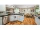 Well-equipped kitchen with stainless steel appliances, granite countertops, and an adjacent dining area with natural light at 1290 Magnolia Park Cir, Cumming, GA 30040