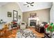 Cozy living room with a fireplace, hardwood floors, comfortable seating, and an inviting atmosphere at 1290 Magnolia Park Cir, Cumming, GA 30040