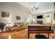 Cozy living room showcasing hardwood floors, a fireplace, and plenty of space for entertaining at 1290 Magnolia Park Cir, Cumming, GA 30040