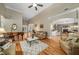 Spacious living room featuring hardwood floors, a piano, comfortable seating, and an open layout at 1290 Magnolia Park Cir, Cumming, GA 30040