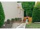 View of the side yard with stone pathway, privacy fence, and well-maintained landscaping at 1290 Magnolia Park Cir, Cumming, GA 30040