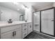 Bathroom with dual vanity, granite counters, and a glass-enclosed shower at 154 Bluffington Way, Marietta, GA 30066