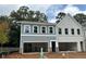 New two story townhome featuring siding and brick with an attached drive-under garage at 154 Bluffington Way, Marietta, GA 30066