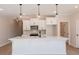 Modern kitchen featuring a large island, stainless steel appliances, and stylish pendant lighting at 154 Bluffington Way, Marietta, GA 30066