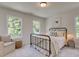 Bright bedroom featuring natural light from the windows, with a wrought iron bed frame at 1956 Deco Dr, Kennesaw, GA 30144
