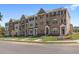 A row of townhouses showcasing brick and stone exteriors with inviting entrances and manicured lawns at 1956 Deco Dr, Kennesaw, GA 30144