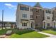 Charming townhome boasts a brick and painted brick facade, a well-manicured lawn, and welcoming curb appeal at 1956 Deco Dr, Kennesaw, GA 30144