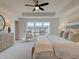 The main bedroom is spacious with a ceiling fan, many windows, and carpeted floors at 1956 Deco Dr, Kennesaw, GA 30144