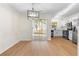 Dining room boasts a stylish light fixture, leading into an updated kitchen with stainless appliances at 6554 Arbor Gate Sw Dr # 4, Mableton, GA 30126