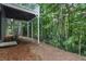 View of the backyard with the house elevated on support beams and a set of stairs at 11020 Knotty Pine Pl, Hampton, GA 30228