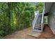 Backyard showing the elevation of the home and stairs going from the back door to the yard at 11020 Knotty Pine Pl, Hampton, GA 30228