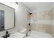 Modern bathroom with black fixtures and tiled shower and tub combination at 11020 Knotty Pine Pl, Hampton, GA 30228