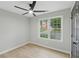 Bedroom features a ceiling fan, LVP floors, and a window with a view at 11020 Knotty Pine Pl, Hampton, GA 30228