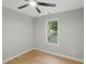 Bedroom features LVP floors, a ceiling fan, and a window with a view at 11020 Knotty Pine Pl, Hampton, GA 30228