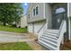 Close up of house showing entryway with stone accents, gray siding and white trim at 11020 Knotty Pine Pl, Hampton, GA 30228