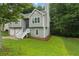 A split-level home boasts a well-manicured lawn and shaded by mature trees at 11020 Knotty Pine Pl, Hampton, GA 30228