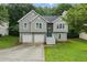 Charming home with gray siding, stone accents, two-car garage and well-maintained lawn at 11020 Knotty Pine Pl, Hampton, GA 30228