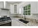 Close-up of the modern kitchen with granite countertops and stainless steel appliances at 11020 Knotty Pine Pl, Hampton, GA 30228