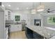 Contemporary kitchen with a granite island, stainless appliances and pendant lighting at 11020 Knotty Pine Pl, Hampton, GA 30228