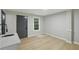 Bright room with light wood flooring, window, and access to the backyard at 11020 Knotty Pine Pl, Hampton, GA 30228