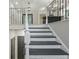 View of the staircase, with white banisters, wrought iron spindles, and access to multiple floors at 11020 Knotty Pine Pl, Hampton, GA 30228
