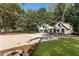 Exterior of beautiful home with lush green lawn, mature trees and large concrete driveway at 1544 Bullard Rd, Powder Springs, GA 30127