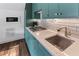 Close-up of the modern kitchenette with green cabinets, quartz counters, and stainless steel appliances at 1544 Bullard Rd, Powder Springs, GA 30127
