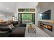 Bright living room features a linear fireplace, modern furniture, and sliding glass doors to the exterior at 1544 Bullard Rd, Powder Springs, GA 30127
