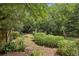 Backyard with wooden fence and lots of green plants, bushes and trees at 1592 Braeburn Se Dr, Atlanta, GA 30316