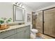 Updated bathroom with granite vanity, glass enclosed shower, and neutral tile at 1592 Braeburn Se Dr, Atlanta, GA 30316