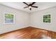Bright bedroom featuring hardwood floors, ceiling fan and two windows allowing natural light at 1592 Braeburn Se Dr, Atlanta, GA 30316