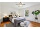 Cozy bedroom with hardwood floors, ceiling fan, and a bright window at 1592 Braeburn Se Dr, Atlanta, GA 30316