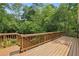 A wooden deck with brown railing offers a relaxing space to enjoy outdoors at 1592 Braeburn Se Dr, Atlanta, GA 30316