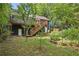Backyard view of blue house, with a deck and stairs to the lawn with garden at 1592 Braeburn Se Dr, Atlanta, GA 30316