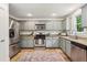 Updated kitchen with stainless steel appliances, granite countertops, and tiled floors at 1592 Braeburn Se Dr, Atlanta, GA 30316