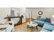 Stylish living room with a blue sofa, white walls, and hardwood floors at 1592 Braeburn Se Dr, Atlanta, GA 30316