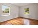 An airy bedroom with hardwood floors and two windows providing natural light at 2855 Monticello Pl, Decatur, GA 30030