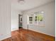 An empty bedroom with hardwood floors, closet, large windows, fresh paint, and access to porch at 2855 Monticello Pl, Decatur, GA 30030