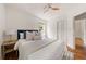 A spacious bedroom with hardwood floors, ceiling fan, a window, a bed and view into the hall at 2855 Monticello Pl, Decatur, GA 30030