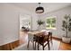 Dining area with a wooden table, stylish light fixture, and hardwood floors at 2855 Monticello Pl, Decatur, GA 30030