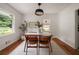 Bright dining area featuring hardwood floors, a modern light fixture, and a view of the backyard at 2855 Monticello Pl, Decatur, GA 30030