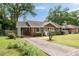 Single-story brick house with a carport and a long driveway, nestled among mature trees at 2855 Monticello Pl, Decatur, GA 30030