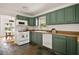 Kitchen with green cabinets, white appliances, and slate tile flooring at 2855 Monticello Pl, Decatur, GA 30030