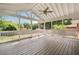 A screened-in porch with a fan and white railing overlooking a lush backyard at 2855 Monticello Pl, Decatur, GA 30030