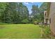 Expansive backyard featuring a lush green lawn and mature trees for privacy at 2868 Wood Park Nw Trce, Kennesaw, GA 30152