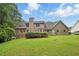 Large backyard with lush lawn, mature trees, and a covered patio, great for entertaining at 2868 Wood Park Nw Trce, Kennesaw, GA 30152