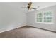 Bedroom with ceiling fan, window, and neutral-colored carpeting at 2868 Wood Park Nw Trce, Kennesaw, GA 30152