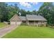 Charming home featuring a two-car garage, front porch, and lush landscaping at 2868 Wood Park Nw Trce, Kennesaw, GA 30152