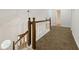 Upstairs hallway featuring carpeted floors, wood railings, and natural light at 2868 Wood Park Nw Trce, Kennesaw, GA 30152
